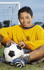 Child sitting on soccer field